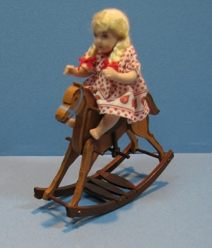 animated demon doll on rocking horse